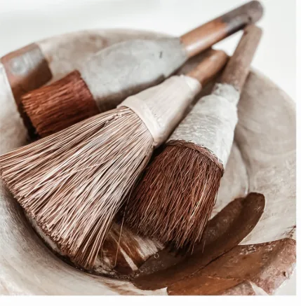 Calligraphy brushes in ceramic bowl